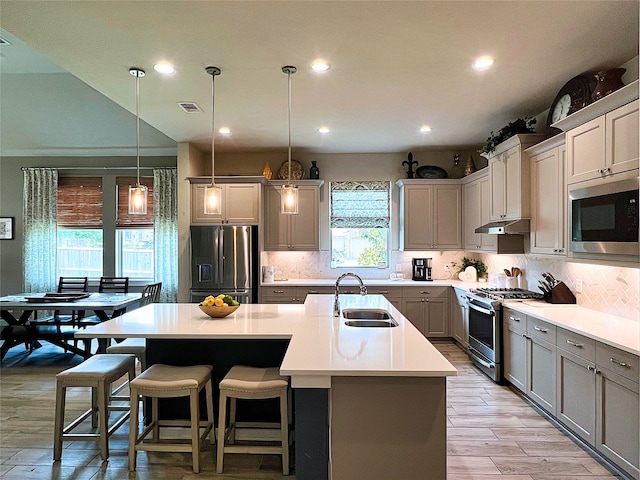 2 Ruchill Cir, Conroe, TX 77304 - kitchen with appliances with stainless steel finishes, gray cabinets, tasteful backsplash, recessed lighting, and a kitchen island with sink