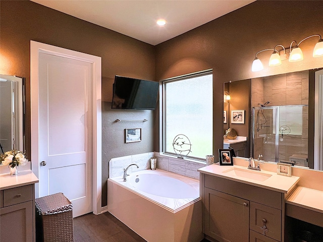 2 Ruchill Cir, Conroe, TX 77304 - full bathroom featuring a stall shower, vanity, a garden tub, and wood finished floors