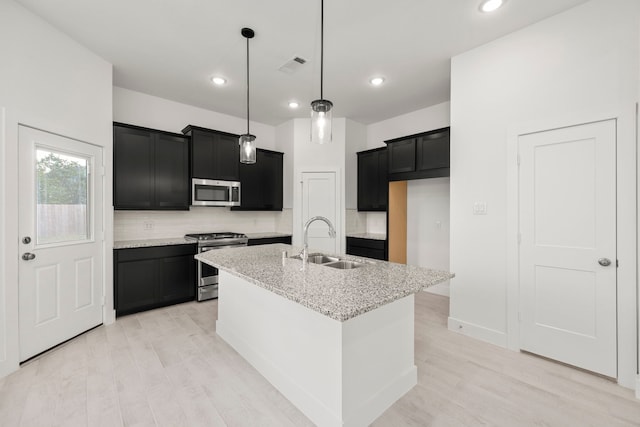 7810 Starfish Arbor Dr, Cypress, TX 77433 - kitchen with appliances with stainless steel finishes, dark cabinets, backsplash, and recessed lighting