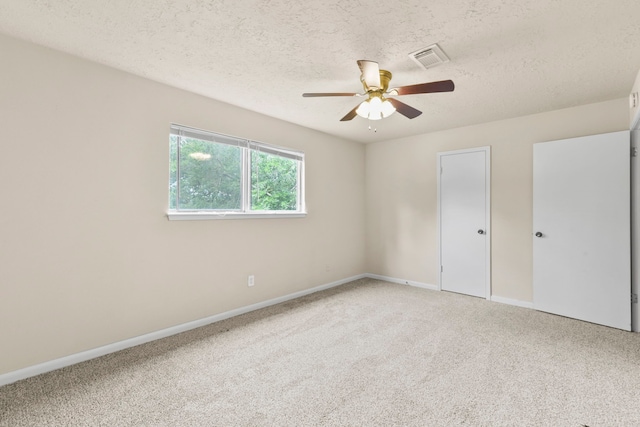 3735 Pineleaf Dr, Houston, TX 77068 - unfurnished bedroom with light colored carpet, a textured ceiling, and ceiling fan