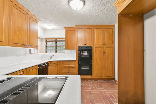 3735 Pineleaf Dr, Houston, TX 77068 - kitchen with black appliances, tasteful backsplash, a textured ceiling, brick patterned flooring, and brown cabinets