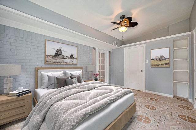 10659 Hazelhurst Dr, Houston, TX 77043 - bedroom with vaulted ceiling, brick wall, and a ceiling fan