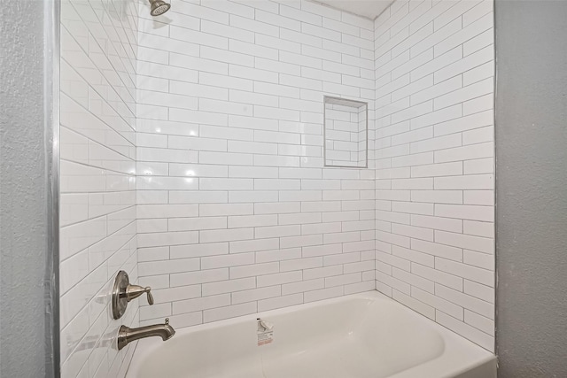 10659 Hazelhurst Dr, Houston, TX 77043 - bathroom with a textured wall and shower / bath combination