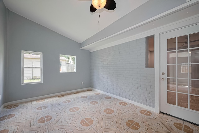 10659 Hazelhurst Dr, Houston, TX 77043 - spare room featuring brick wall, lofted ceiling, ceiling fan, and light tile patterned floors