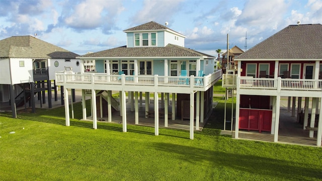 2408 Sandpiper, Crystal Beach, TX 77650 - rear view of property with roof with shingles, a yard, and a wooden deck