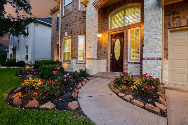 3315 Tulip Ranch Dr, Katy, TX 77494 - exterior entry at dusk with stone siding and brick siding