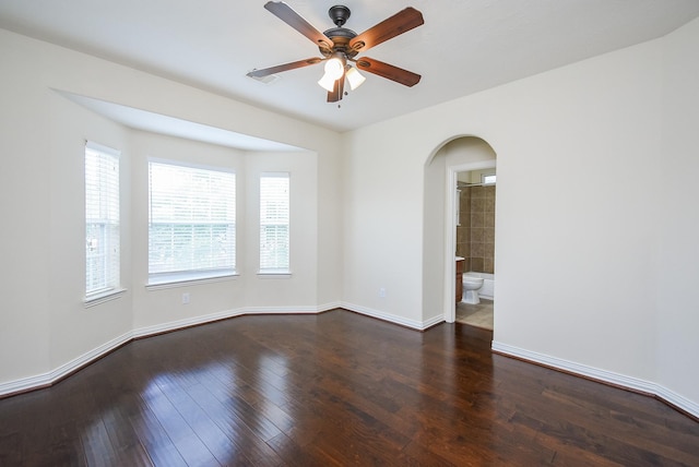3315 Tulip Ranch Dr, Katy, TX 77494 - spare room featuring arched walkways, a ceiling fan, and dark wood-style floors