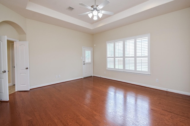 3315 Tulip Ranch Dr, Katy, TX 77494 - unfurnished room with ceiling fan, arched walkways, a raised ceiling, and wood finished floors