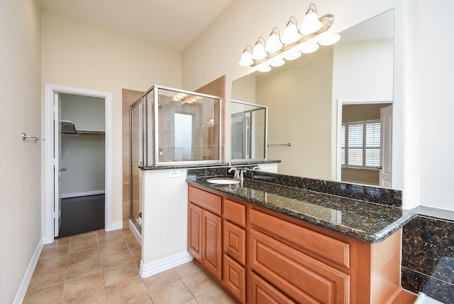 3315 Tulip Ranch Dr, Katy, TX 77494 - bathroom with vanity, a stall shower, a walk in closet, and tile patterned flooring