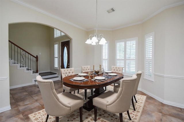 3315 Tulip Ranch Dr, Katy, TX 77494 - dining room featuring healthy amount of natural light, arched walkways, a chandelier, crown molding, and stairs