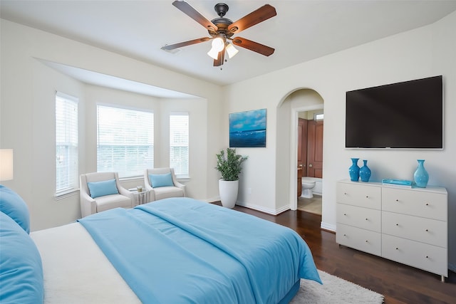3315 Tulip Ranch Dr, Katy, TX 77494 - bedroom with dark wood-style flooring, arched walkways, ensuite bathroom, and ceiling fan