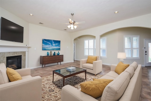 3315 Tulip Ranch Dr, Katy, TX 77494 - living area featuring arched walkways, a ceiling fan, a glass covered fireplace, recessed lighting, and tile patterned floors