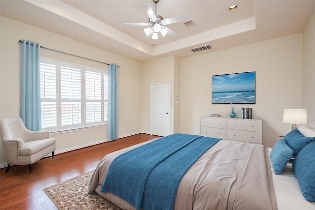 3315 Tulip Ranch Dr, Katy, TX 77494 - bedroom featuring wood finished floors, a tray ceiling, a ceiling fan, and recessed lighting