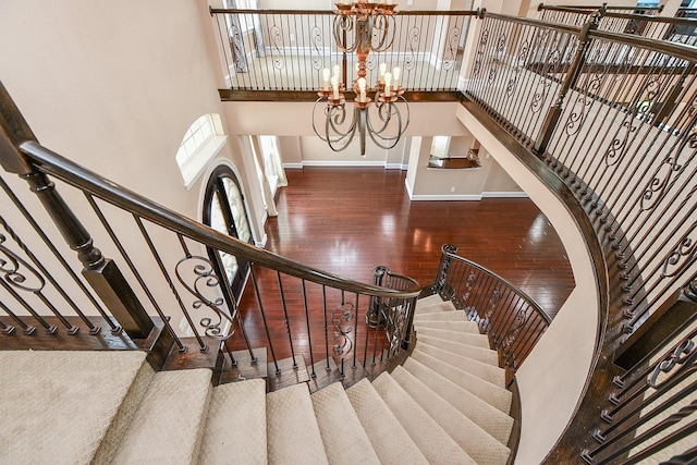 25518 Millbrook Bend Ln, Katy, TX 77494 - staircase featuring a chandelier, wood finished floors, and a high ceiling