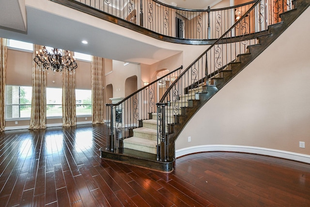 25518 Millbrook Bend Ln, Katy, TX 77494 - stairway featuring a high ceiling, arched walkways, a chandelier, and wood finished floors