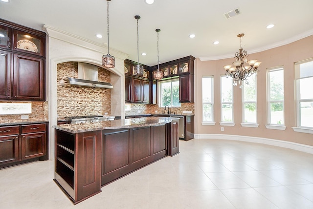 25518 Millbrook Bend Ln, Katy, TX 77494 - kitchen featuring wall chimney exhaust hood, ornamental molding, tasteful backsplash, dark stone counters, and a chandelier