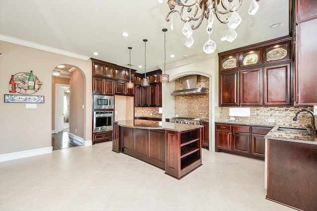 25518 Millbrook Bend Ln, Katy, TX 77494 - kitchen featuring appliances with stainless steel finishes, arched walkways, wall chimney exhaust hood, a kitchen island, and crown molding