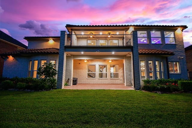 25518 Millbrook Bend Ln, Katy, TX 77494 - back of property featuring a balcony, a patio, stucco siding, a lawn, and a ceiling fan