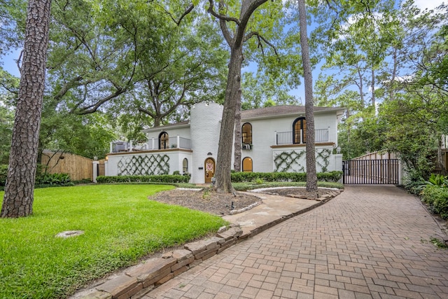 11 Twin Circle Dr, Houston, TX 77042 - view of front of home featuring a gate, decorative driveway, a balcony, and stucco siding