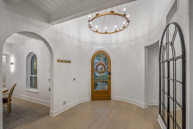 11 Twin Circle Dr, Houston, TX 77042 - entrance foyer with arched walkways, wood finished floors, and a chandelier