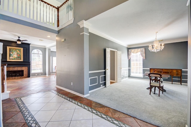 11715 Orchard Mountain Dr, Pasadena, TX 77059 - tiled dining space featuring crown molding, a fireplace, inlaid floor details, a chandelier, and a ceiling fan