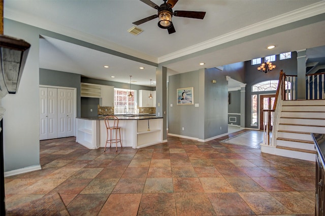 11715 Orchard Mountain Dr, Pasadena, TX 77059 - kitchen featuring dark countertops, ornamental molding, ceiling fan, white cabinetry, and stone tile floors