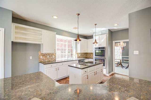 11715 Orchard Mountain Dr, Pasadena, TX 77059 - kitchen featuring stainless steel double oven, decorative backsplash, white cabinets, pendant lighting, and recessed lighting