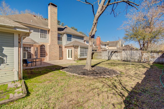 11715 Orchard Mountain Dr, Pasadena, TX 77059 - back of property featuring a chimney, a patio, brick siding, and french doors