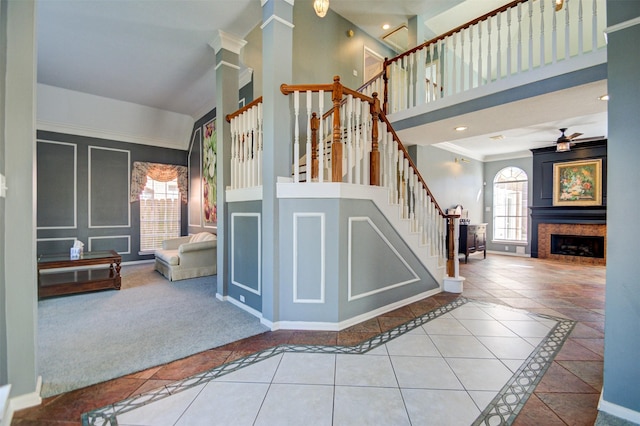 11715 Orchard Mountain Dr, Pasadena, TX 77059 - stairway featuring plenty of natural light, inlaid floor details, a high ceiling, a fireplace, and tile patterned flooring