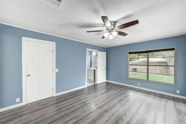 224 Maddox St, Clute, TX 77531 - unfurnished bedroom featuring wood finished floors, ensuite bathroom, a textured ceiling, crown molding, and ceiling fan