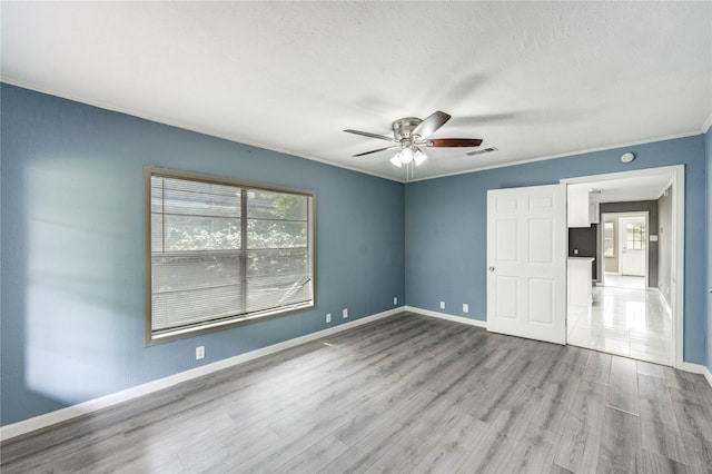 224 Maddox St, Clute, TX 77531 - unfurnished bedroom with wood finished floors, ornamental molding, and a ceiling fan