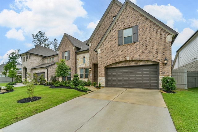 17794 Misty Brook Ln, Conroe, TX 77302 - french provincial home featuring brick siding, a garage, driveway, and stone siding