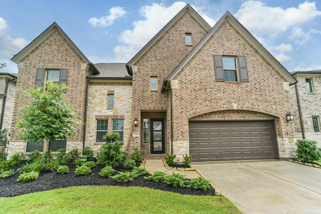 17794 Misty Brook Ln, Conroe, TX 77302 - view of front of home featuring concrete driveway, stone siding, an attached garage, and brick siding