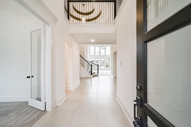 17794 Misty Brook Ln, Conroe, TX 77302 - foyer entrance with stairway, a towering ceiling, and light tile patterned flooring