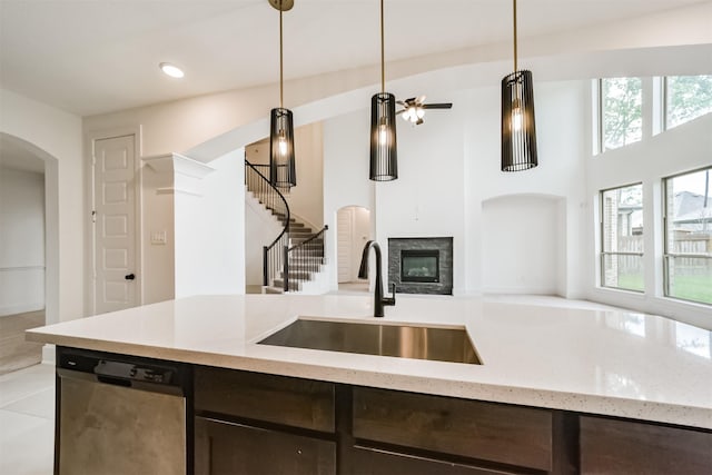 17794 Misty Brook Ln, Conroe, TX 77302 - kitchen featuring stainless steel dishwasher, open floor plan, dark brown cabinetry, plenty of natural light, and recessed lighting