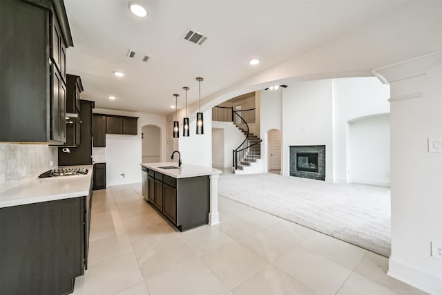 17794 Misty Brook Ln, Conroe, TX 77302 - kitchen with stainless steel dishwasher, light countertops, recessed lighting, arched walkways, and light carpet