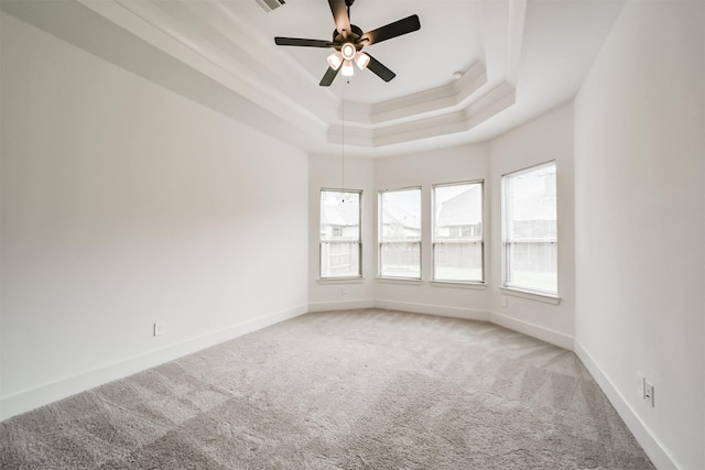 17794 Misty Brook Ln, Conroe, TX 77302 - empty room featuring carpet floors, a tray ceiling, and ceiling fan