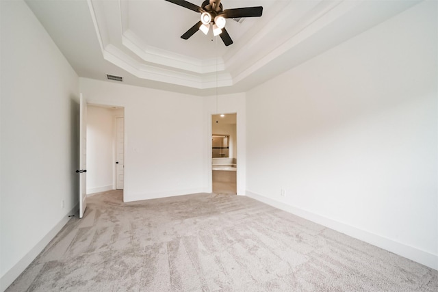 17794 Misty Brook Ln, Conroe, TX 77302 - empty room featuring a tray ceiling, carpet flooring, ceiling fan, and ornamental molding