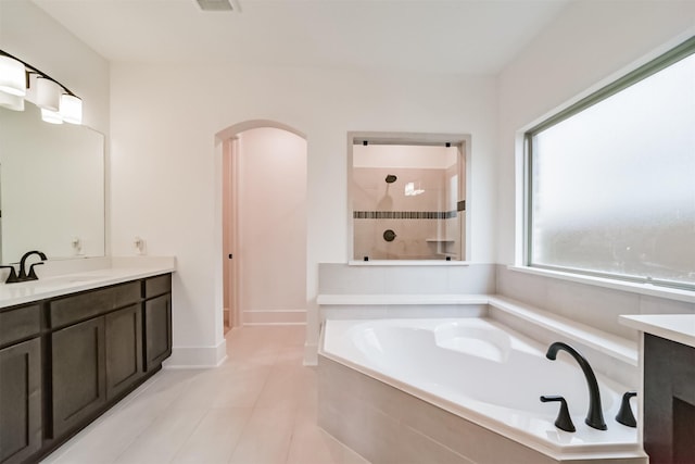 17794 Misty Brook Ln, Conroe, TX 77302 - bathroom featuring vanity, a garden tub, tiled shower, and tile patterned floors