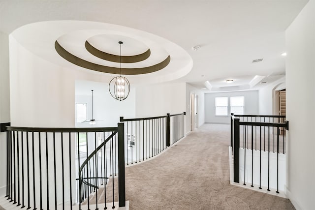 17794 Misty Brook Ln, Conroe, TX 77302 - hallway with a raised ceiling, carpet floors, an upstairs landing, and a chandelier