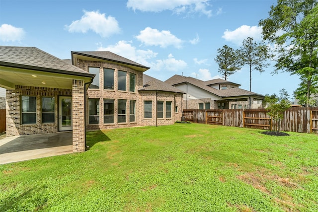 17794 Misty Brook Ln, Conroe, TX 77302 - back of property with a fenced backyard, brick siding, a patio area, and roof with shingles