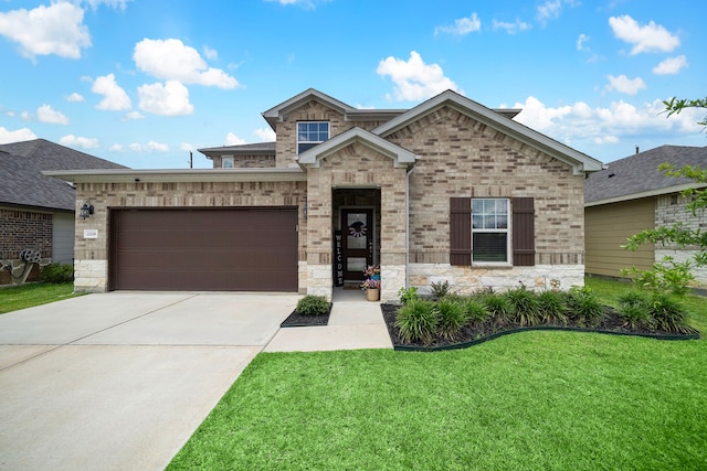 2218 Royal Ann Way, Tomball, TX 77375 - view of front of house with a front yard, concrete driveway, an attached garage, stone siding, and brick siding