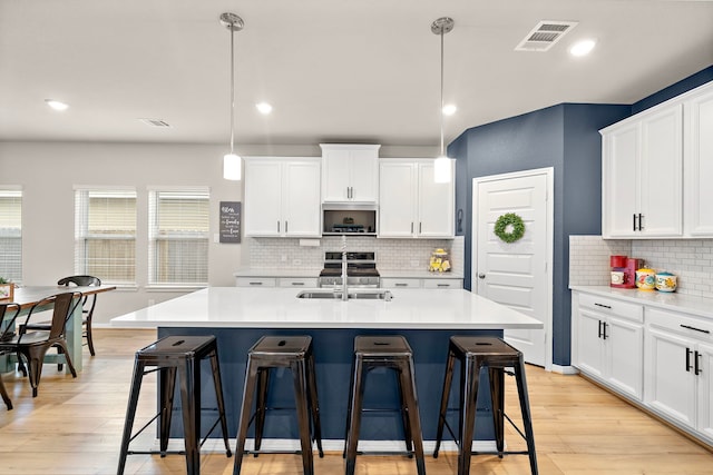 2218 Royal Ann Way, Tomball, TX 77375 - kitchen with a kitchen breakfast bar, light wood-style flooring, light countertops, and recessed lighting