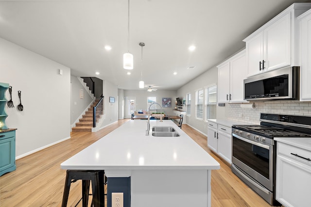 2218 Royal Ann Way, Tomball, TX 77375 - kitchen featuring appliances with stainless steel finishes, light wood-type flooring, light countertops, backsplash, and recessed lighting