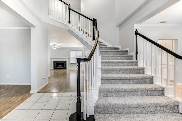 16023 Cutten Rd, Houston, TX 77070 - stairs with crown molding, a ceiling fan, wood finished floors, and a premium fireplace