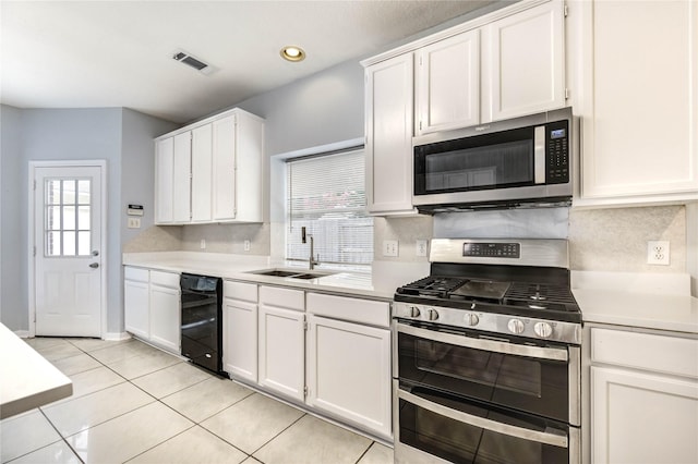 16023 Cutten Rd, Houston, TX 77070 - kitchen featuring stainless steel appliances, light countertops, white cabinetry, and recessed lighting