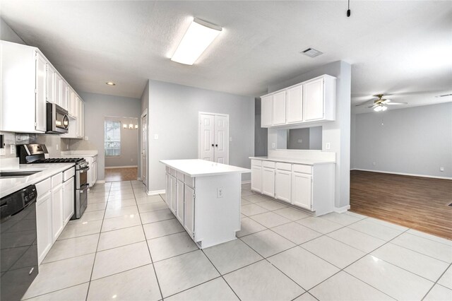 16023 Cutten Rd, Houston, TX 77070 - kitchen with appliances with stainless steel finishes, a center island, light tile patterned floors, a ceiling fan, and recessed lighting