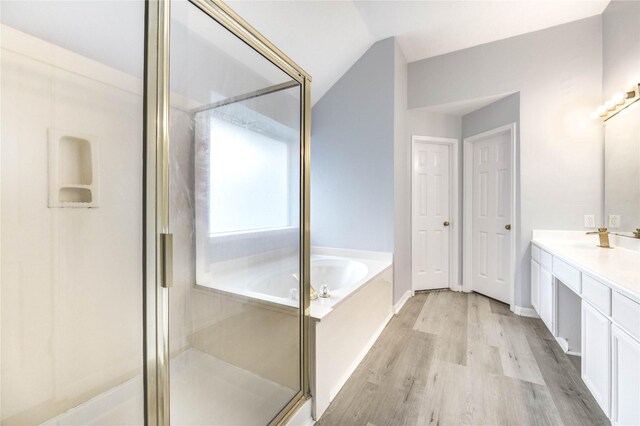 16023 Cutten Rd, Houston, TX 77070 - full bathroom with a garden tub, vanity, wood finished floors, a shower stall, and lofted ceiling