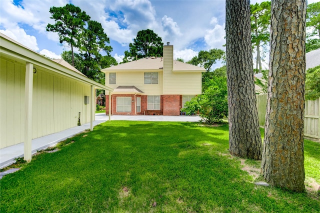 16023 Cutten Rd, Houston, TX 77070 - rear view of property featuring brick siding, a chimney, and a patio area