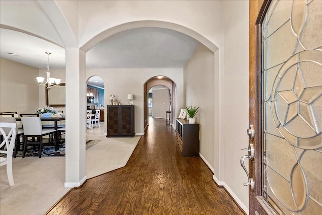 4472 Gerona St, League City, TX 77573 - foyer with arched walkways, wood finished floors, and a chandelier